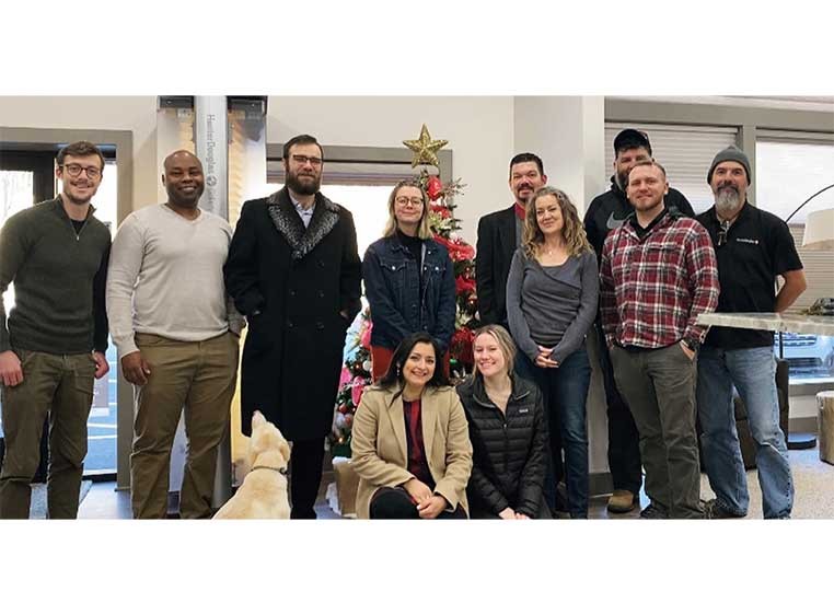 A group photo of the dealership staff standing in a row