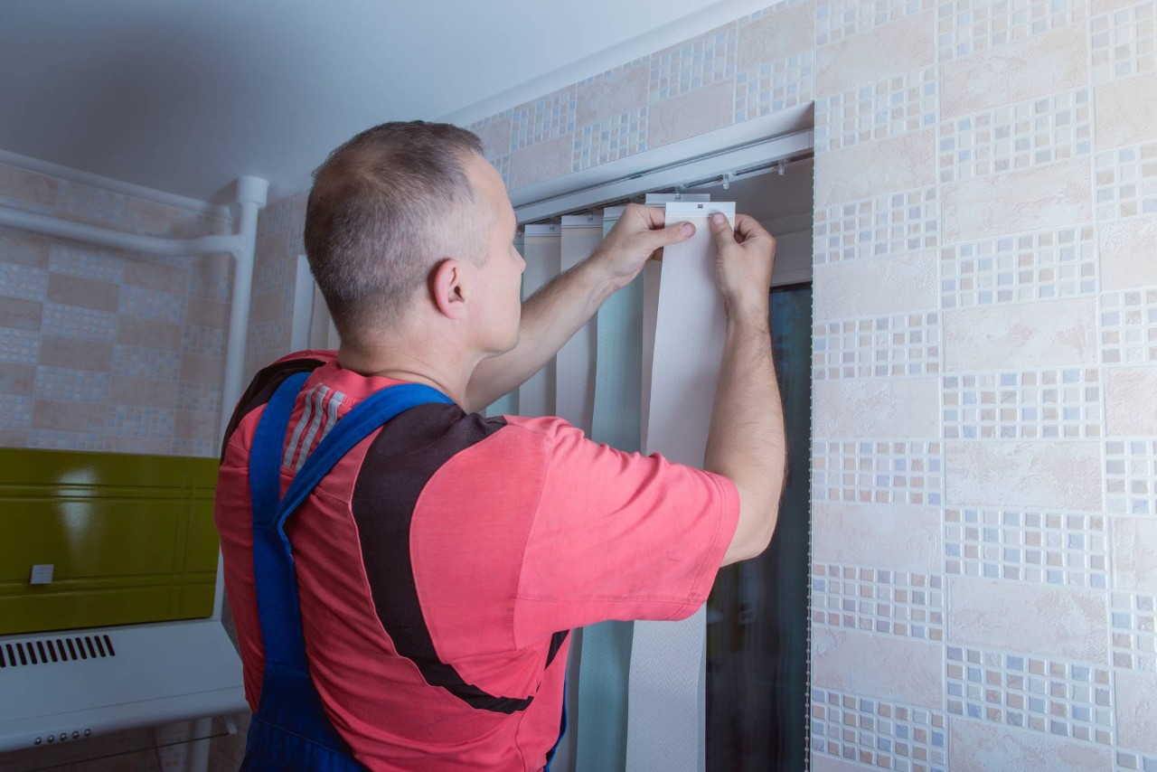 Someone replacing damaged vertical blinds near Boone, North Carolina (NC)