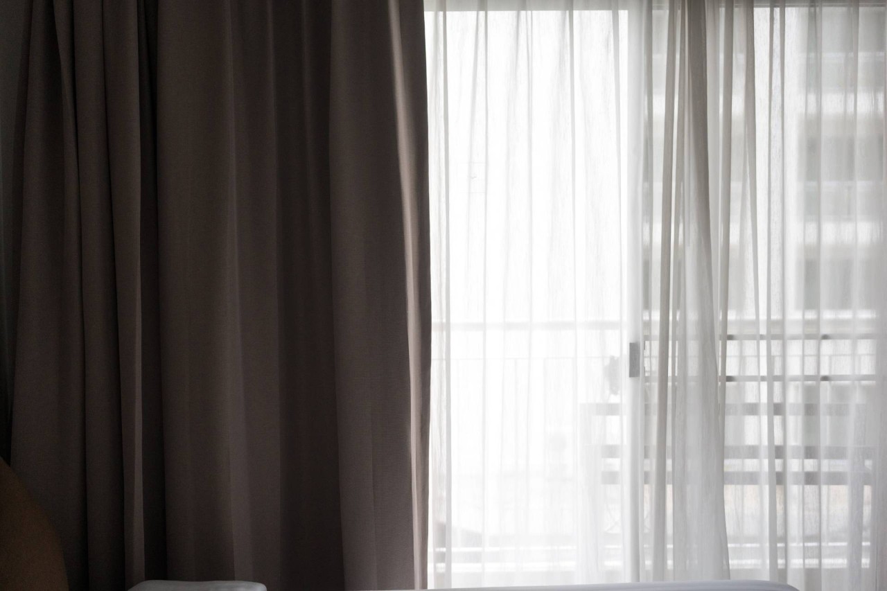  Light gray and sheer curtains in front of a sliding door at Appalachian Blind & Closet Co. near Boone North Carolina (NC)