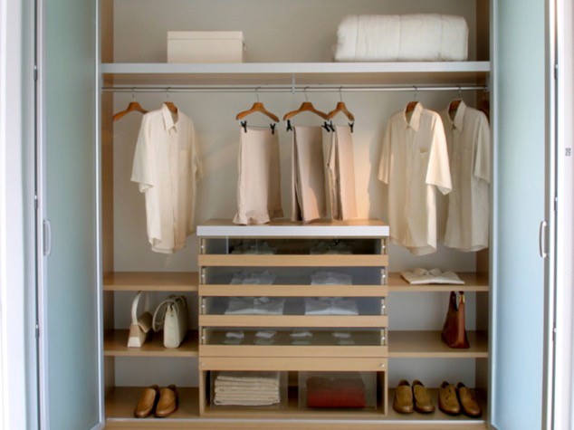 Closet that is well organized but has minimum clothing and shoes